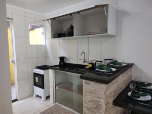 a kitchen with a sink and a counter top at Lofts Primavera Centro Histórico Paraty in Paraty +38 photos