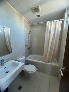 a bathroom with a toilet and a tub and a sink at Seaview 2 bedroom unit near Mactan International Airport in Punta Engaño +62 photos