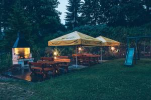 a group of tables and umbrellas in a yard at Apartmány Barto21 in Bartošovice v Orlických Horách