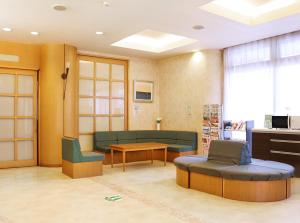 a waiting room with a couch and a table at Island Hotel in Nagano