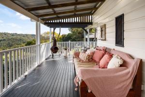 a porch with a couch on a deck at Beam Creek Cottage - Montville in Montville