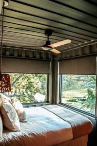 a bedroom with a bed and a large window at Hidden Creek Cabin in Bellthorpe