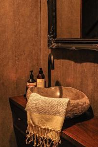 a bathroom with a sink and a mirror at Hidden Creek Cabin in Bellthorpe