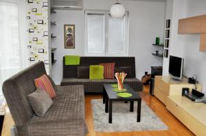 a living room with a couch and a table at Alexandar's Place Apartment in Skopje