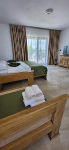 a bedroom with two beds and towels on the floor at Casa Boeriu in Sfântu Gheorghe +58 photos