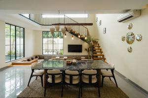 a dining room with a table and chairs at Casa Amore 4BR Seminyak in Seminyak