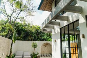 a house with a staircase in the middle of a courtyard at Casa Amore 4BR Seminyak in Seminyak