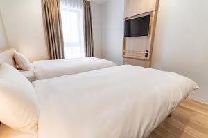 Postel nebo postele na pokoji v ubytování Kansai International Airport Hotel 11