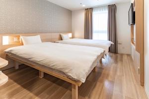 Postel nebo postele na pokoji v ubytování Kansai International Airport Hotel 11