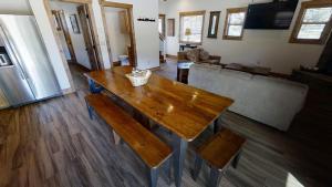 a living room with a wooden table and a couch at Lost in Paradise - Pet Friendly - Hot Tub - WiFi - Fireplace - Grill - On the River - Fire Pit in Red River