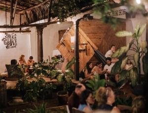 a group of people sitting in a room at Caracolito Hostal in Las Peñitas