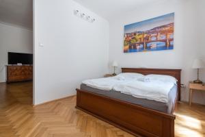 Un dormitorio con una cama y un cuadro en la pared. en Historic Spirit at Studio under the Prague Castle, en Praga