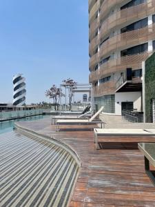 a deck with benches and a building at Hotel Sonata Angelopolis in Lomas de Angelopolis