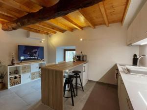 a kitchen with a large island with stools in it at Casa do Tronco in Bragança