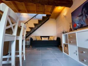 a living room with a couch and a staircase at Casa do Tronco in Bragança