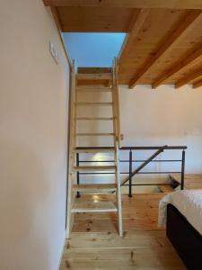 a wooden staircase in a room with a ceiling at Casa do Tronco in Bragança