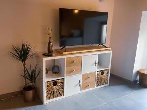 a white cabinet with a television on top of it at Casa do Tronco in Bragança +4 photos