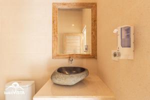 a bathroom with a bowl sink on a counter at Kembang Kuning in Uluwatu