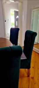 a living room with two chairs and a table at Apartmani Neven in Irig