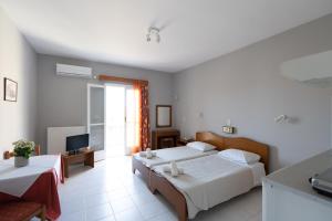 Postel nebo postele na pokoji v ubytování Ammousa Hotel Apartments