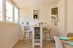 a kitchen with two stools and a counter with a table at 20 Apartment Centre in Bucharest