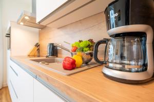 a kitchen counter with a blender and fruits and vegetables at Ferienwohnung Blickwinkel in Lohme +2 photos