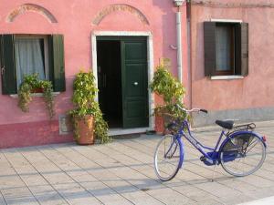 a blue bike parked on a sidewalk in front of a building at Ca' Noemi in Venice-Lido