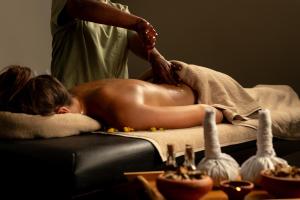 a woman laying on a couch getting a massage at Ayugiri Ayurveda Wellness Resort Sigiriya in Sigiriya