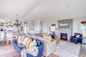 a living room with a couch and a fireplace at Searenity Now Depoe Hills in Depoe Bay