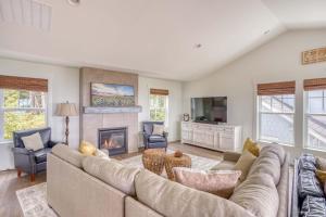 a living room with a couch and a fireplace at Searenity Now Depoe Hills in Depoe Bay