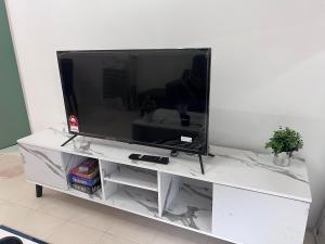 a flat screen tv on a white entertainment center at Ayaan Cozy Homestay Cameron Highland in Tanah Rata