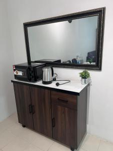 a mirror on top of a dresser in a room at Ayaan Cozy Homestay Cameron Highland in Tanah Rata