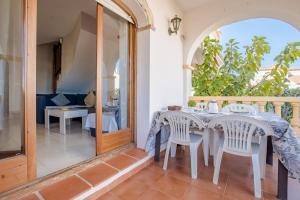 a dining room with a table and chairs on a balcony at Casa Azahara by MarCalma in El Casalot