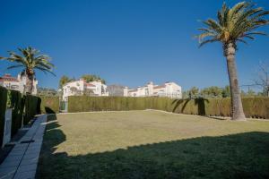 a large yard with palm trees and houses at Casa Azahara by MarCalma in El Casalot