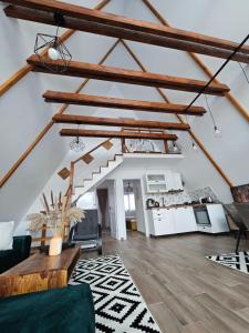an attic living room with wooden beams at Ambiance Aframe in Câmpulung Moldovenesc