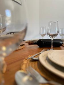 a wooden table with plates and wine glasses on it at Melina house in Ayiá
