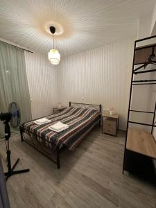 a bedroom with a bed with a lamp and a ladder at Melina house in Ayiá