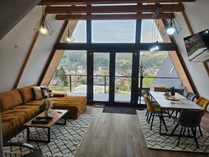 a living room with a couch and a table at Ambiance Aframe in Câmpulung Moldovenesc