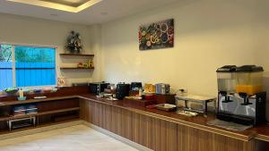 a bar in a restaurant with a counter at The charlotte smart hotel lopburi in Lop Buri