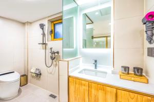 a bathroom with a sink and a toilet at The Hutong Courtyard-Very close to Tiananmen Square,Forbidden City,Wangfujing Commercial Street,The hotel has a terrace,Free coffee,Free laundry,Near the subway st ation in Beijing
