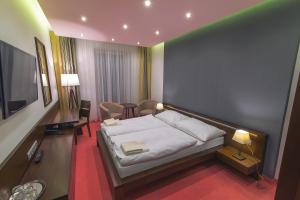 Säng eller sängar i ett rum på Hotel Arkada
