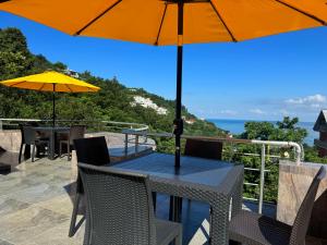a table with an umbrella on top of a balcony at Royal House in Kvariati