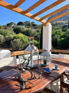 a wooden table with a lamp on a deck at Haroupia Hillside Villa in Kalymnos