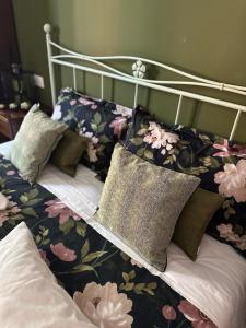 a bed with floral sheets and pillows on it at Agriturismo il maniero in Ancona +118 photos