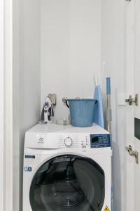 a washing machine with a bowl on top of it at Sleek Lvl 75 Apt w Skyline Views in Aurora Complex in Melbourne +2 photos