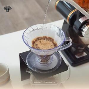 a person is making a drink in a blender at The Garden Suites New in Solo