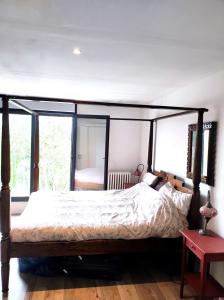 a bedroom with a large bed with a canopy at Villa de luxe proche Paris, aéroport et Disneyland in Le Perreux-Sur-Marne
