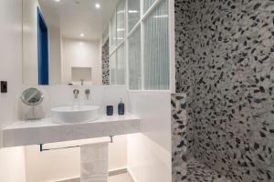 a white bathroom with a sink and a shower at Infinity Blue next to the sea in Kalamata +29 photos