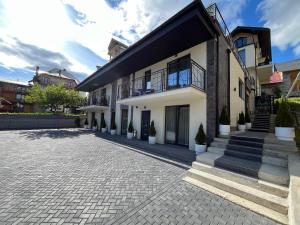 a house with a brick driveway in front of it at Krucha in Bukovel