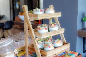 a wooden shelf with pots of plants on it at Sleep Mai Thapae Chiang Mai Old City Lifestyle Hotel in Chiang Mai +35 photos